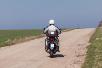 Biker riding on a motorcycle. Driving the empty road on a motorcycle tour journey