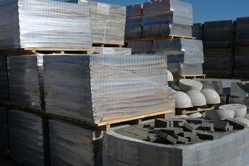 Pavement stones on market. Paving slabs store. Cobblestone on pallets.