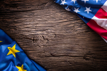 Flags of american and european union on rustic oak board. EU and USA flags together diagonally.