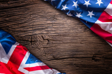 Flags of american and united kingdom on rustic oak board. UK and USA flags together diagonally. © weyo