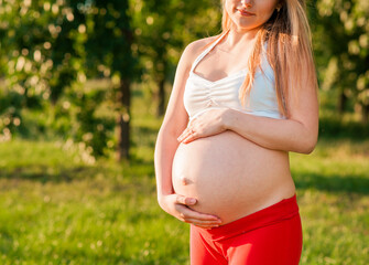 Fototapeta na wymiar Pregnancy, sport and health lifestyle - young pregnant woman