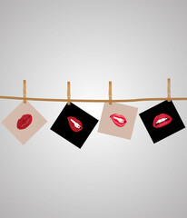 Photo of the lips hanging on a rope, clothespins hold a photo. Photo lips on a light background.