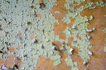 green peeling paint on orange wall