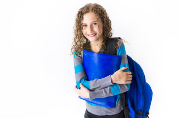Fototapeta premium girl of 9 years in a school uniform poses in studio.