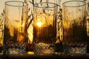 Three glasses at sunset