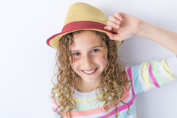 Portrait of 9 years old girl with curly hair, isolated on gray