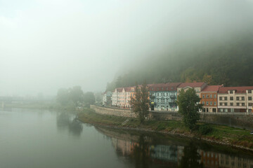 mystic town on the river in the fog