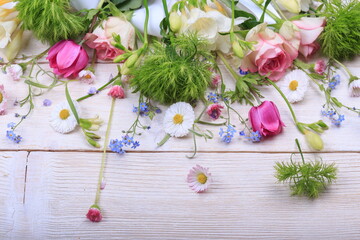 Obraz na płótnie Canvas Festive flower composition on the white wooden background. Overhead view.