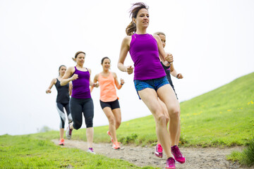 group of people enjoying in the fitness having fun running outside