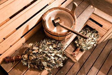 Empty wooden sauna room with ladle, bucket ready to be used © malkovkosta