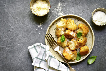 Roasted cauliflower with yogurt sauce and cheese.Top view.