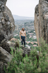 Climbing man between rocks
