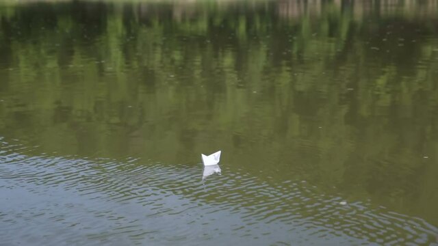 Paper boat floating on water