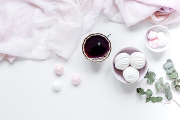 sweet lunch with marsh-mallow and spring flowers for woman on white background top view