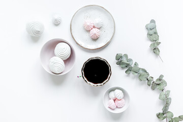 light breakfast with marsh-mallow and coffee on white table background top view