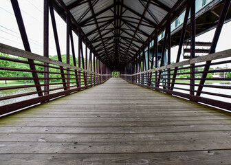 Wooden Boardwalk walking bridge over water 