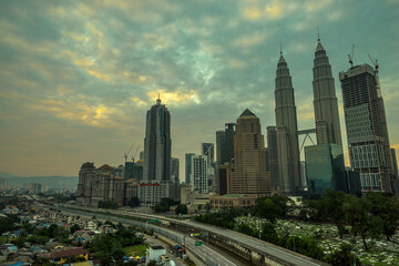 A cloudy sunrise in Kuala Lumpur, the capital of Malaysia. Its modern skyline is dominated by the 451m tall KLCC, a pair of glass and steel clad skyscrapers.