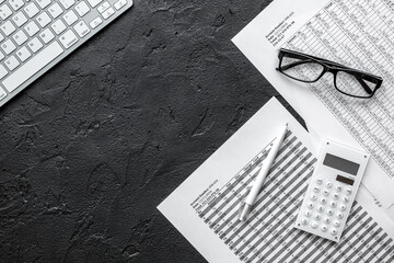 business accounter work with taxes and keyboard on black office desk top view mock up