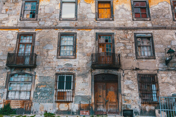 Facade of abandoned house buildings, Porto, Portugal. Ancient ruins of Europe.