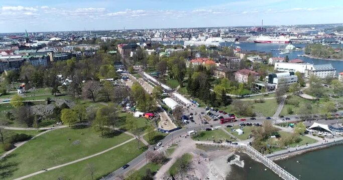 Kaivopuisto, Cinema 4k aerial rising view of a event at brunnsparken, on a sunny summer day, in Helsinki, Finland