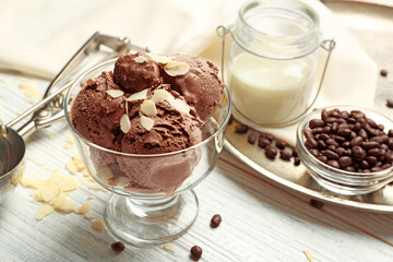 Delicious chocolate ice cream in glass bowl on wooden table