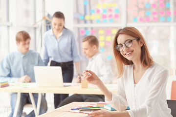 Fototapeta premium Beautiful young woman working in office