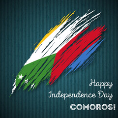 Comoros Independence Day Patriotic Design. Expressive Brush Stroke in National Flag Colors on dark striped background. Happy Independence Day Comoros Vector Greeting Card.