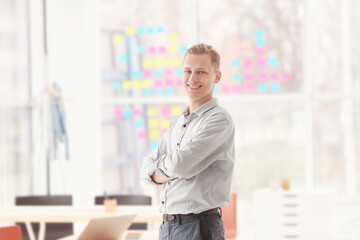 Young man standing in office