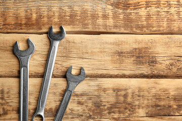 Combination wrenches on wooden background
