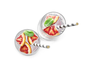 Glasses of refreshing lemonade with red orange and mint on white background