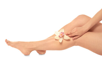 Epilated legs and hand holding flower on white background