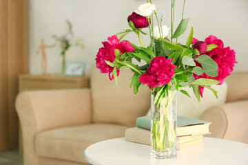 Beautiful peonies and eustoma flowers in vase on light table