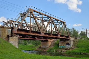 Railway bridge across the river Oredezh at Vyritsa in the summer
