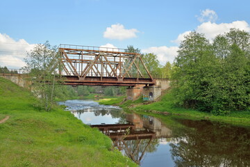 Railway bridge across the river Oredezh at Vyritsa in the summer