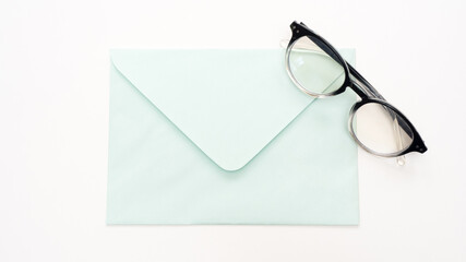 Office desk table with  envelope and glasses close up Top view copy space