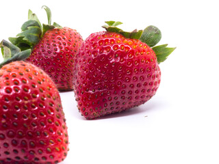Closeup shot of fresh strawberries. Isolated on white background.