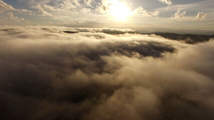 Naklejka na ściany i meble Aerial View over the clouds