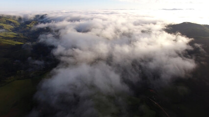 Aerial View of clouds in a Mountain Valley