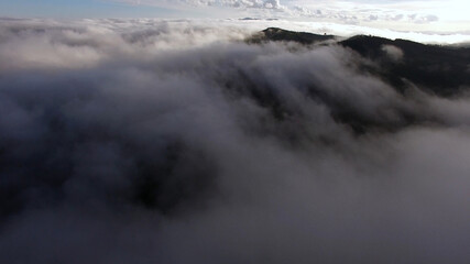 Aerial View of clouds in a Mountain Valley