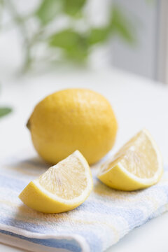 Yellow Lemon with slice closeup on the table.