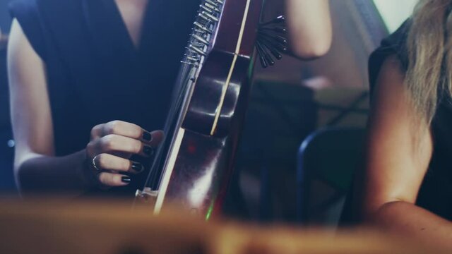 National Ukrainian musical instrument. Pandora music player. Kobza Ukrainian stringed musical instrument. Close up of orchestra playing bandura. Bandura player music. Traditional musical instrument