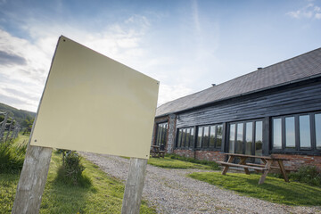 Blank Sign Outside a Vacation Brick Barn House