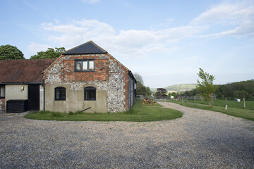 Brick Barn House and Surrounding Gravel Driveway