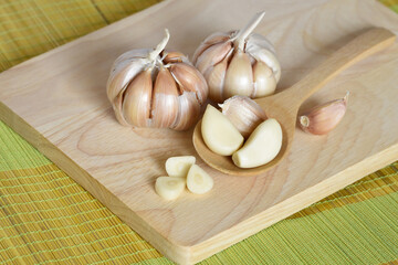 Prepared garlic bulb on chopping board for cooking