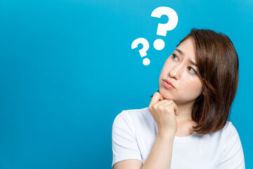 young woman with question marks.