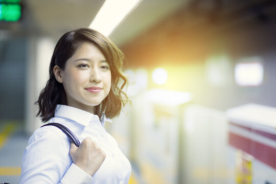 young woman waiting the subway on platform.