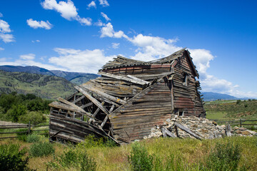 Weathered Old Barn Collapsing Under a Blue Sky