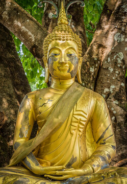 Ancient cracked statue of Buddha image. The old Buddhism ruin in Thailand.