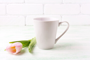 Fototapeta na wymiar White coffee latte mug mockup with pink tulip