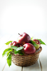 Organic apples with leaves in  basket